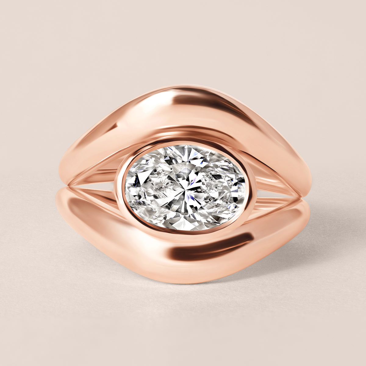 Top-down birds-eye view of Liora oval bezel engagement ring in 18K rose gold paired with a matching plain gold contour band.