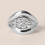 Top-down birds-eye view of Liora oval bezel engagement ring in white gold or platinum paired with a matching plain metal contour band.