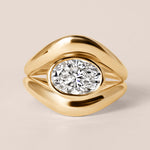 Front view of Liora oval bezel engagement ring in 18K rose gold showing the warm copper tones and horizontal bezel setting.