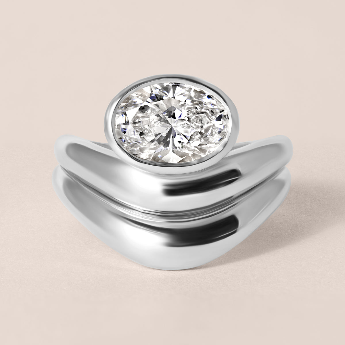 Top-down birds-eye view of Liora oval bezel engagement ring in white gold or platinum paired with a matching diamond contour band.