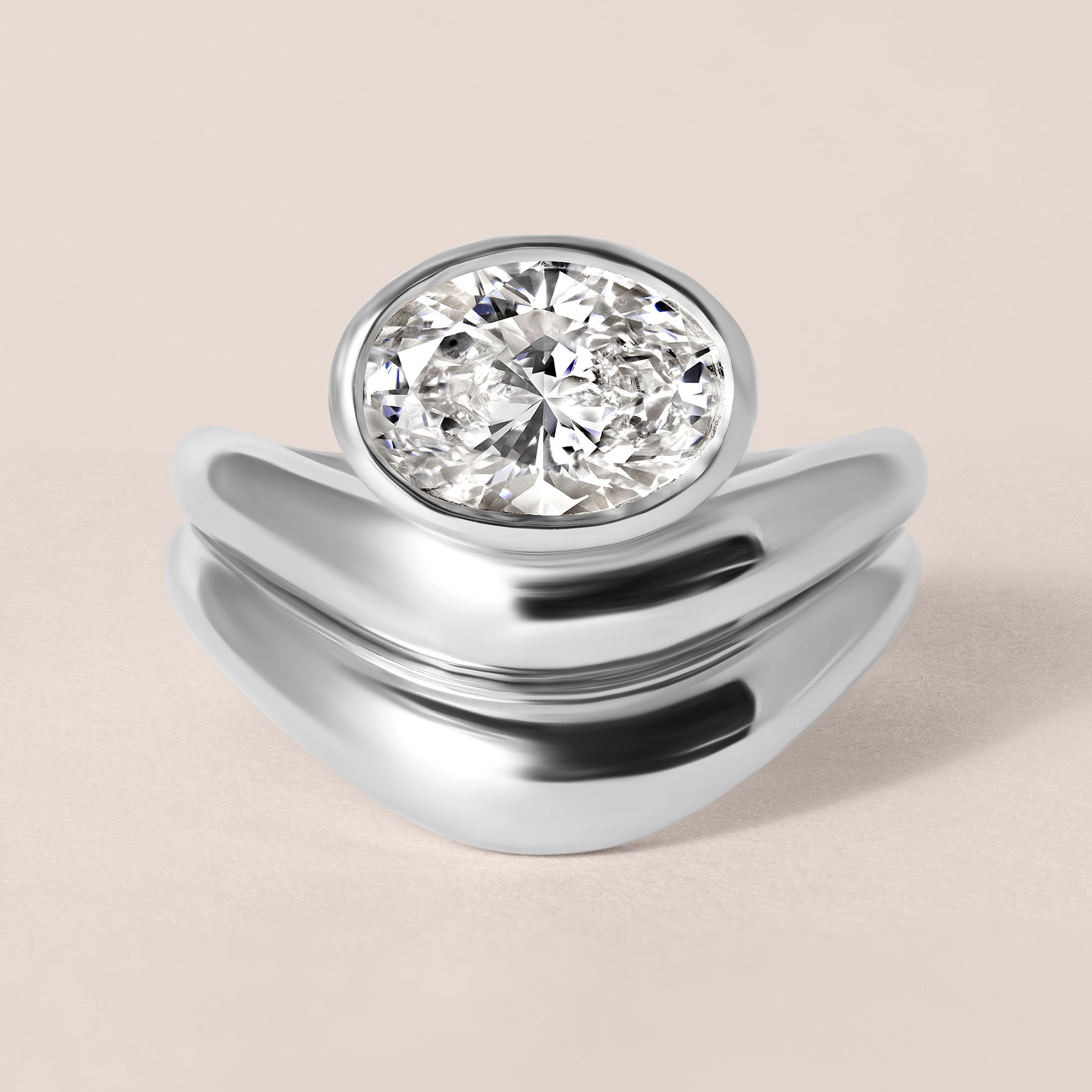 Top-down birds-eye view of Liora oval bezel engagement ring in white gold or platinum paired with a matching diamond contour band.