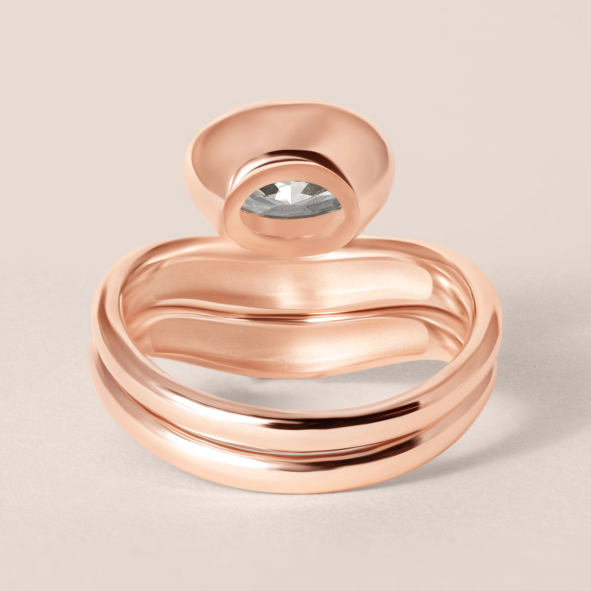 Back view of Liora oval bezel engagement ring stacked with a diamond contour band in 18K rose gold showing the complete matching set alignment.
