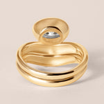 Back view of the Liora oval bezel engagement ring stacked with a diamond contour band in 18K yellow gold showing flush alignment.