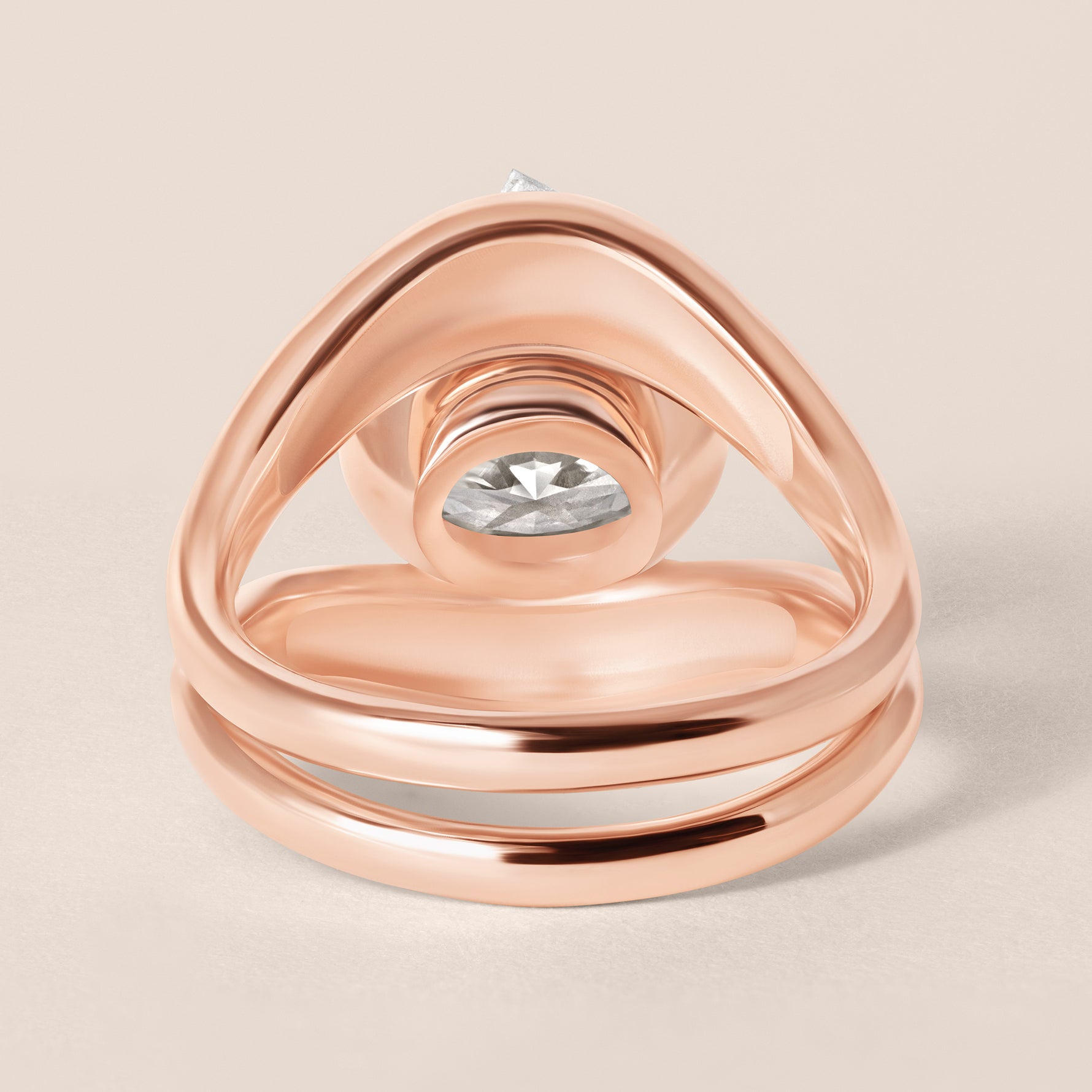 Back view of Liora oval bezel engagement ring stacked with a plain metal contour band in 18K rose gold showing the seamless stacked appearance.