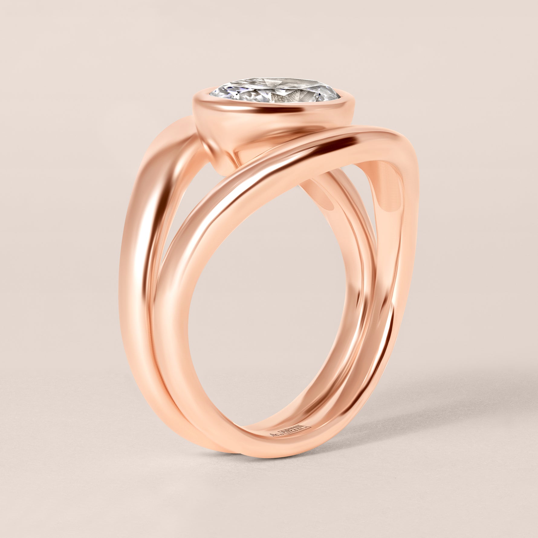 Side profile view of Liora oval bezel engagement ring stacked flush with a plain contour band in 18K rose gold.