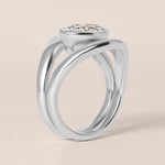 Side profile view of Liora oval bezel engagement ring stacked flush with a plain contour band in white gold or platinum.