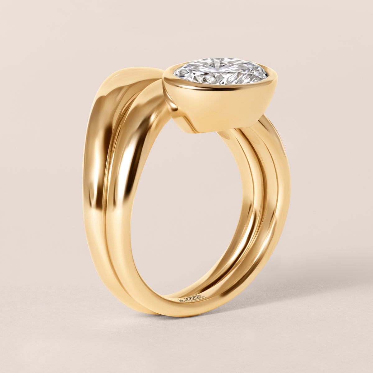 Side profile architectural view of Liora oval bezel engagement ring stacked with a diamond contour band in 18K yellow gold.