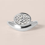 Front view of Liora oval bezel engagement ring in white gold or platinum featuring a horizontal bezel-set center diamond.