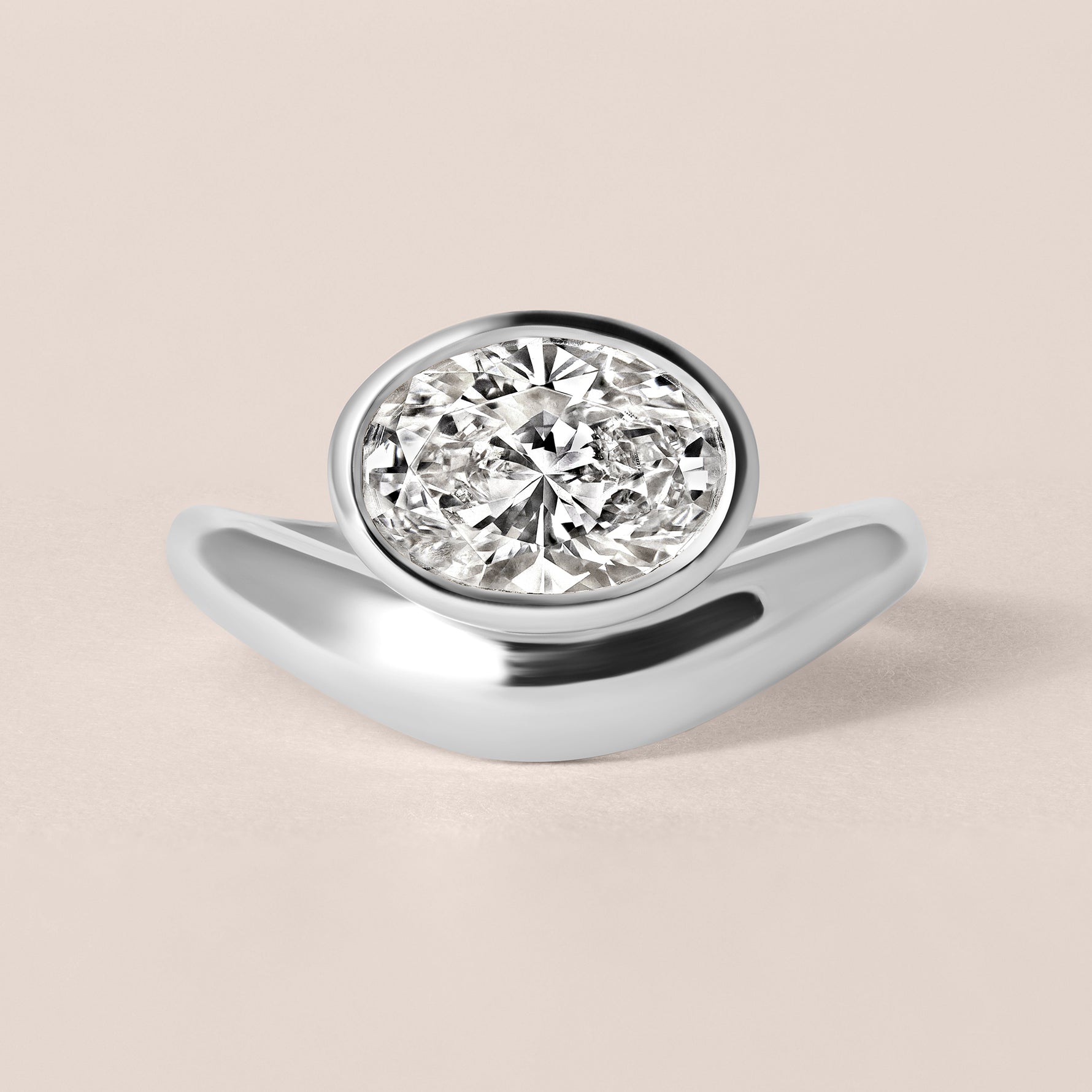 Front view of Liora oval bezel engagement ring in white gold or platinum featuring a horizontal bezel-set center diamond.
