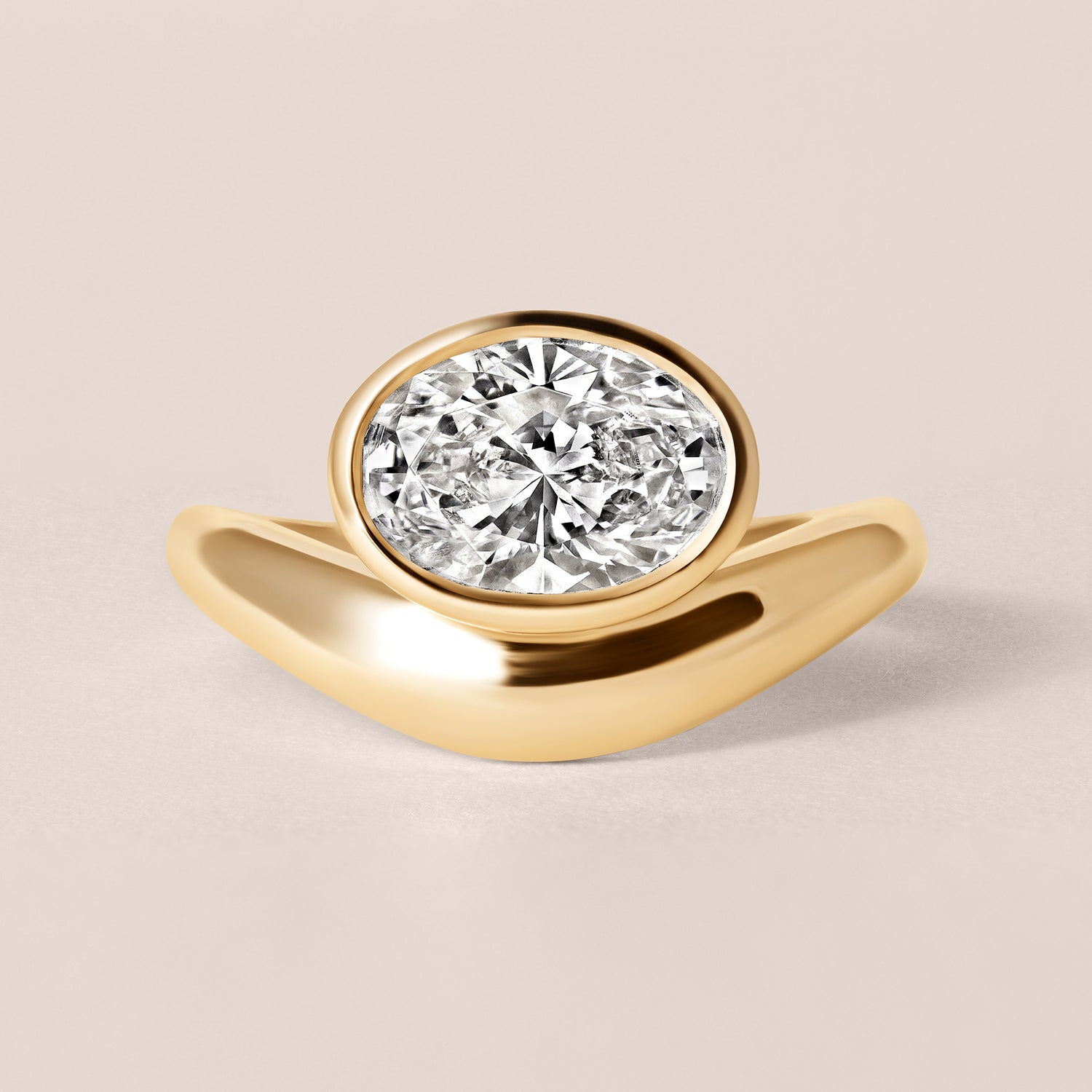 Abtin and Company Liora oval bezel engagement ring in 18K yellow gold, front view showing the split-band silhouette and horizontal bezel setting.