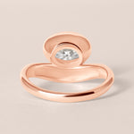 Back structural view of Liora oval bezel engagement ring in 18K rose gold showcasing the solid gold under-bezel architecture.