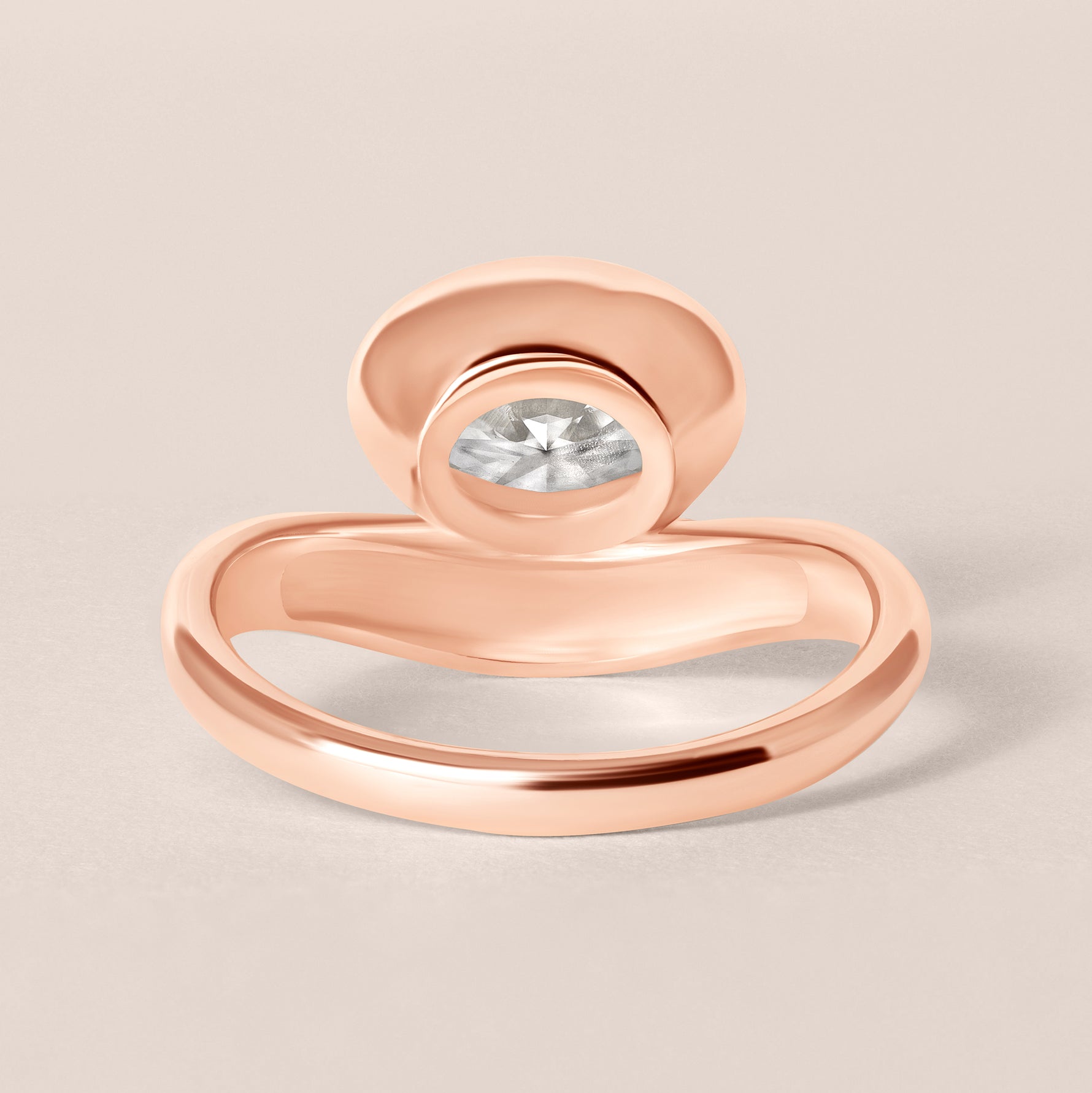 Back structural view of Liora oval bezel engagement ring in 18K rose gold showcasing the solid gold under-bezel architecture.